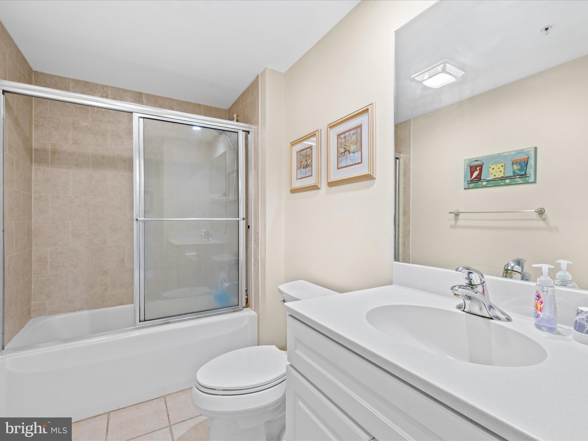 11900 Coastal Highway, Unit 102 Ocean City, MD 21842 - Photo 25 of 39 a bathroom with a sink toilet and shower