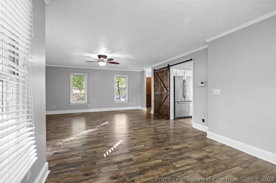 1205 Crossbend Court Fayetteville, NC 28314 - Photo 10 of 37 a view of an empty room with a window and wooden floor