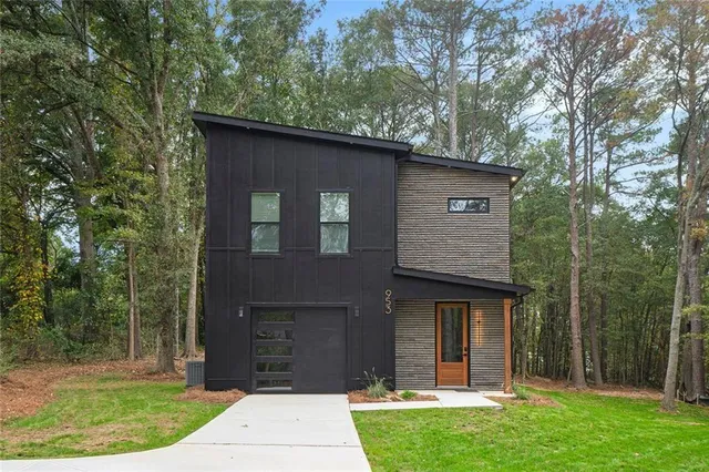 a front view of a house with a garden