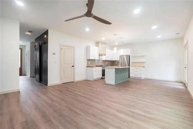 a view of kitchen with wooden floor and electronic appliances
