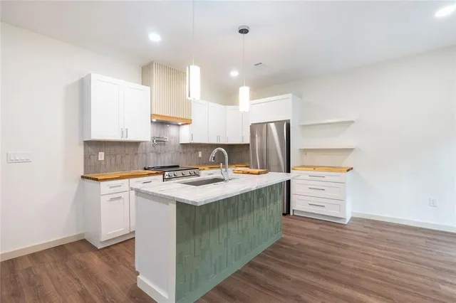 a kitchen with stainless steel appliances a stove and a refrigerator