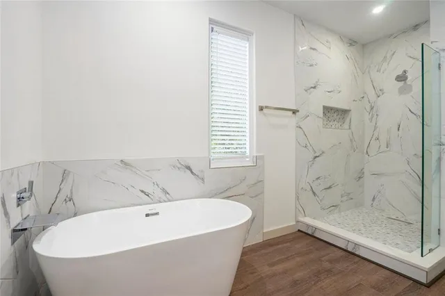 a bathroom with a bathtub and shower
