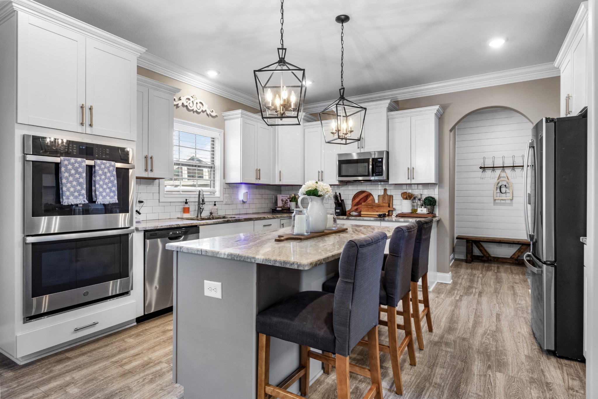 532 Bowden Drive Clarksville, TN 37043 - Photo 9 of 47 a kitchen with stainless steel appliances granite countertop a stove a refrigerator a oven a sink a stove and a dining table with wooden floor