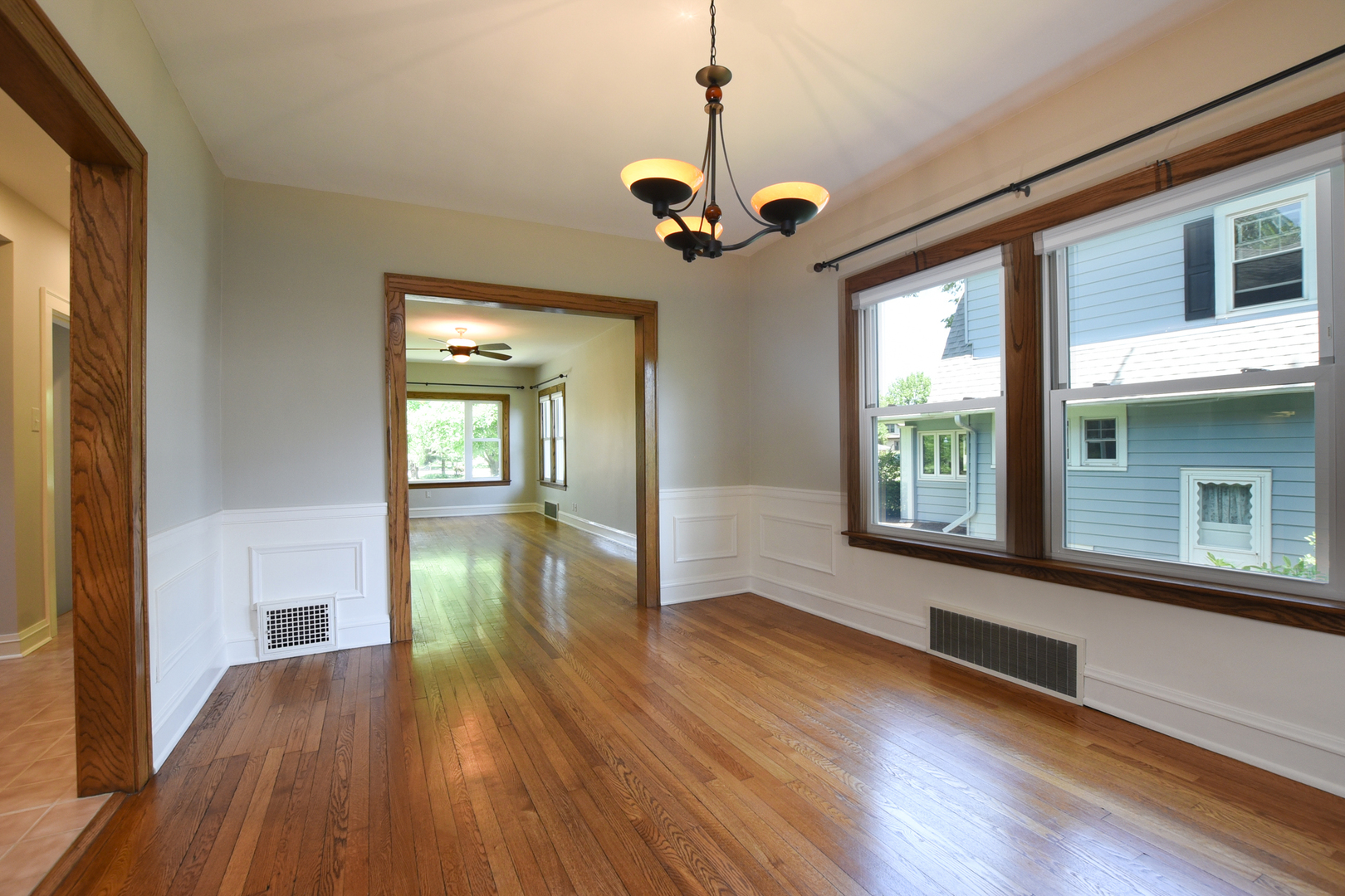 347 Herrick Road Riverside, IL 60546 - Photo 5 of 28 a view of hallway with wooden floor and a chandelier