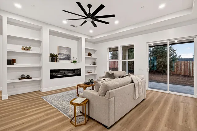 a living room with a fireplace and cabinets