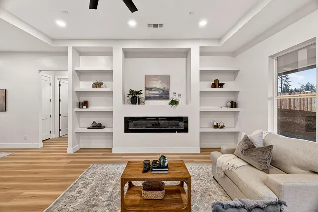 a large kitchen with stainless steel appliances granite countertop a sink a stove a refrigerator and island with wooden floor