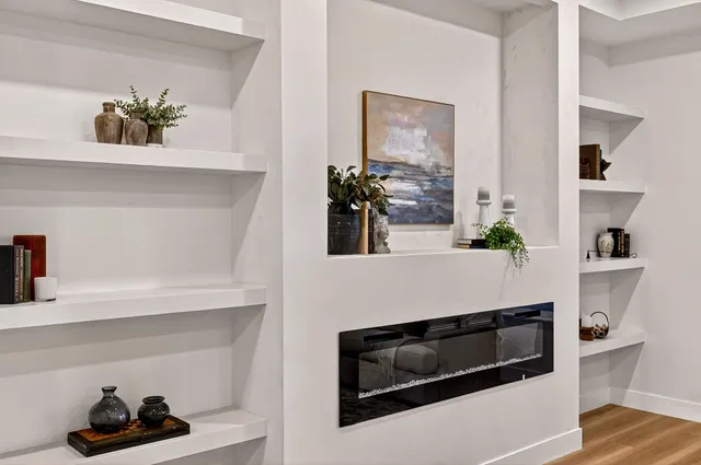 a kitchen with a stove and a white cabinets