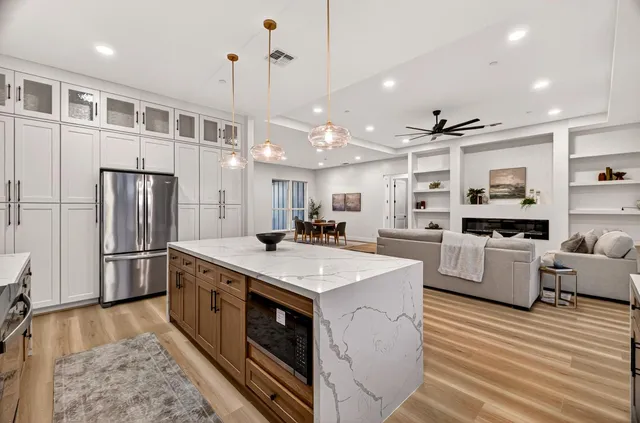 a bathroom with a sink vanity mirror and toilet
