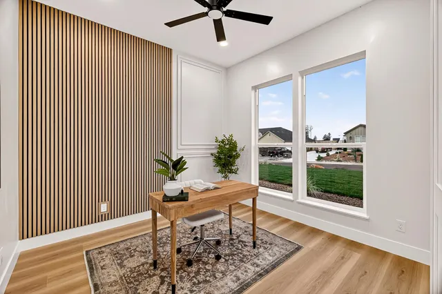 a spacious bedroom with a large bed and a potted plant