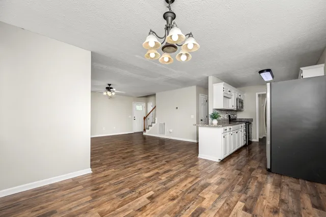 a kitchen with stainless steel appliances granite countertop a sink and a stove