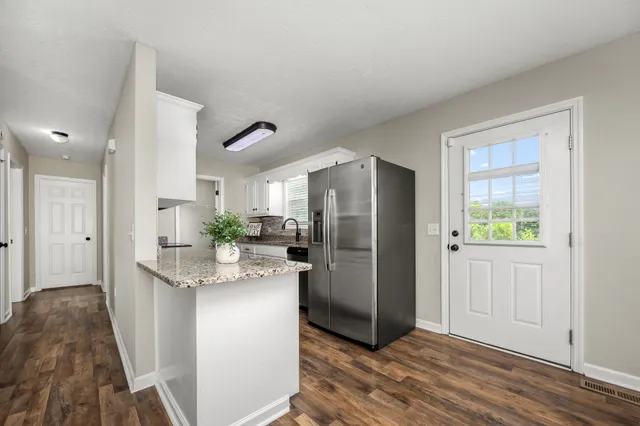 a view of small space with wooden floor and closet