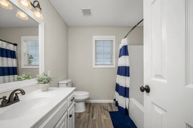 a view of balcony with wooden floor and fence
