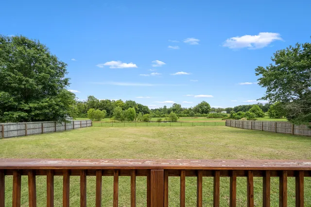 a front view of a house with a garden and deck