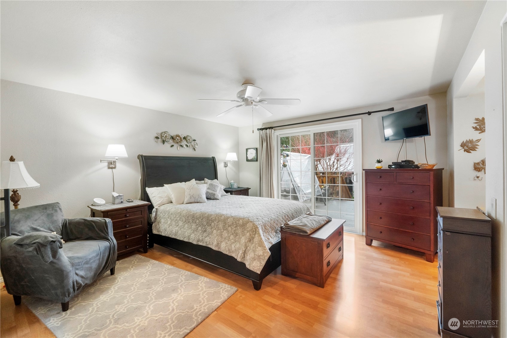 4906 200th Street Southeast Bothell, WA 98012 - Photo 23 of 40 a spacious bedroom with a bed and wooden floor