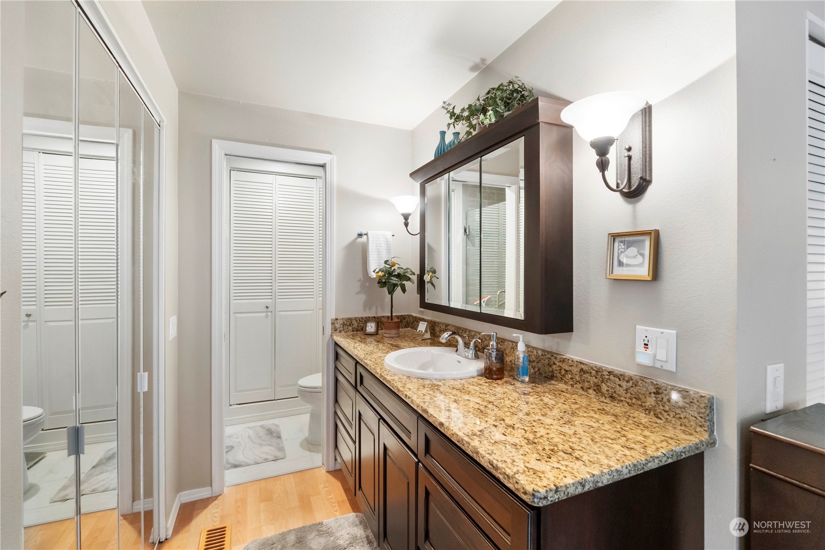 4906 200th Street Southeast Bothell, WA 98012 - Photo 25 of 40 a bathroom with a granite countertop sink and a mirror