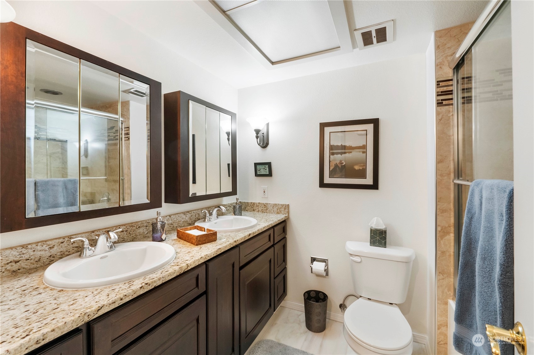 4906 200th Street Southeast Bothell, WA 98012 - Photo 30 of 40 a bathroom with a double vanity sink toilet mirror and shower