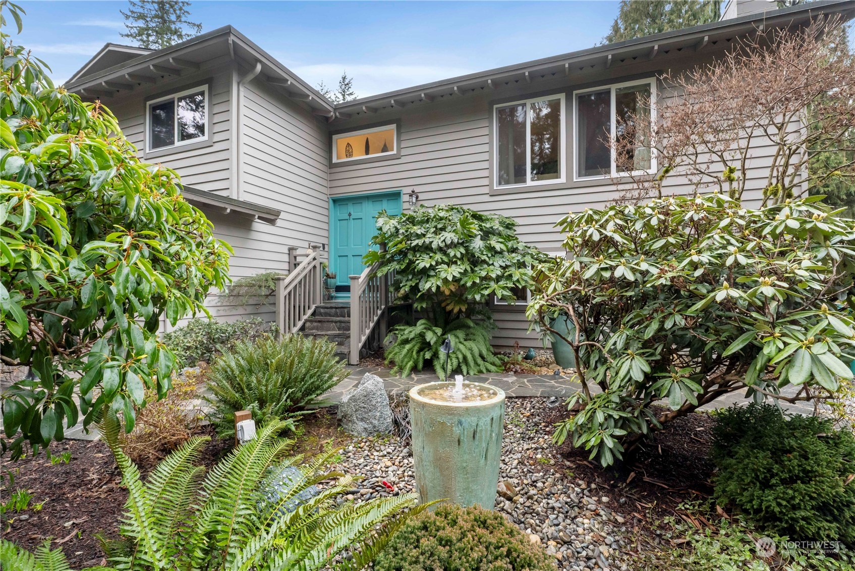 4906 200th Street Southeast Bothell, WA 98012 - Photo 6 of 40 a view of a house with potted plants and a fountain