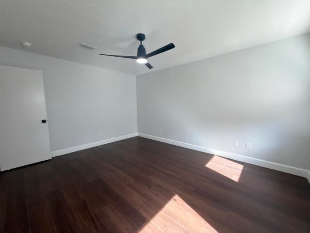 a bedroom with furniture and a large window
