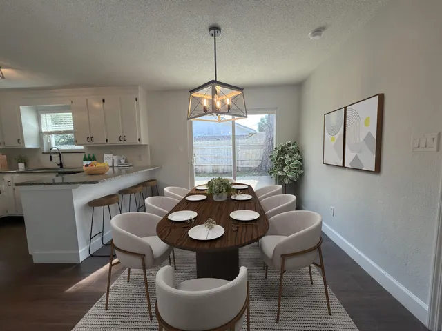 a view of a dining room furniture and window
