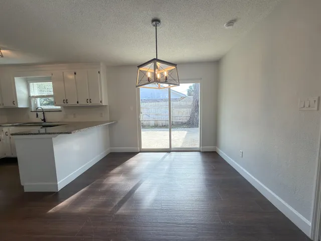 a view of a kitchen with a sink and window
