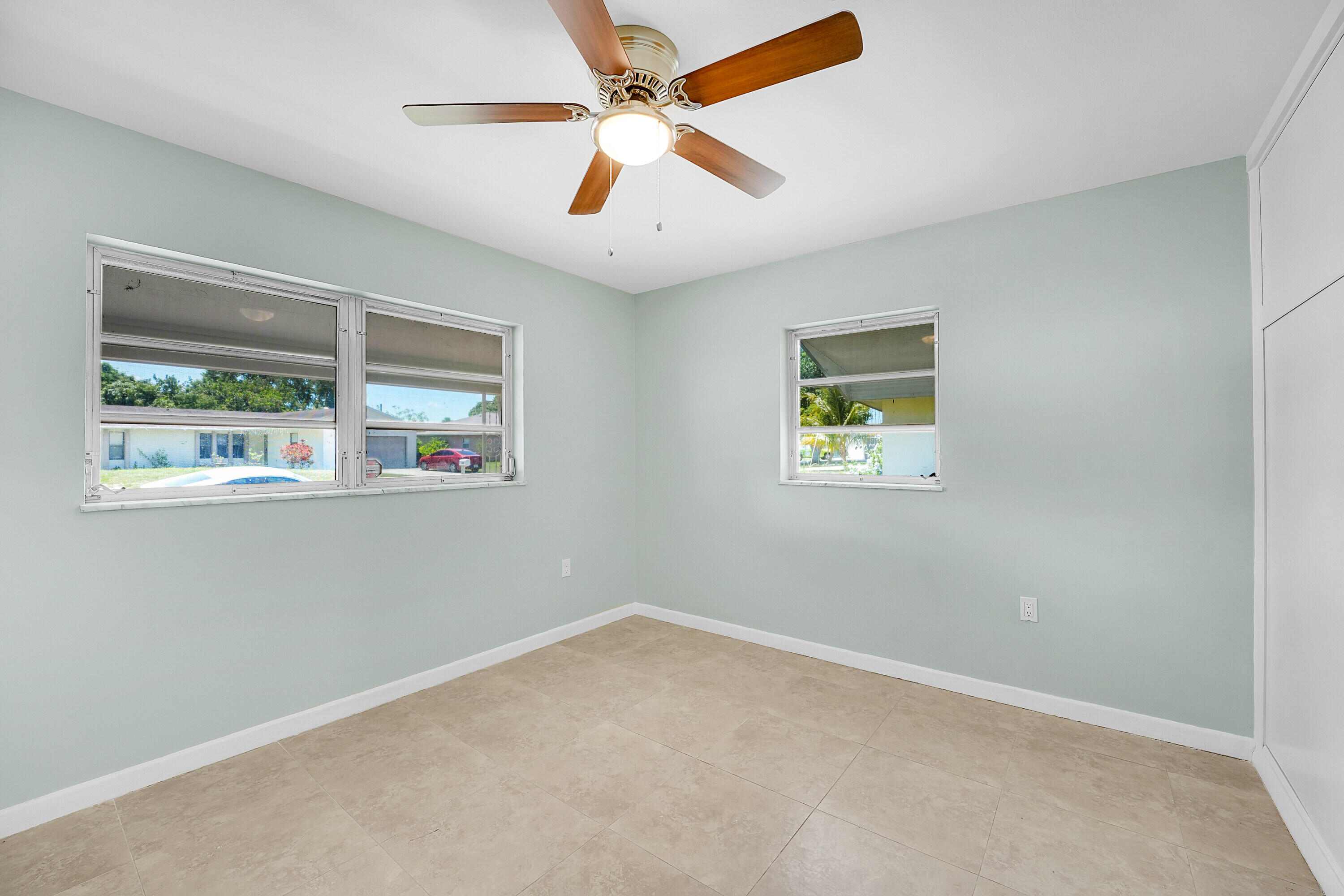 302 West Arbor Avenue Port St. Lucie, FL 34952 - Photo 11 of 25 an empty room with windows and fan