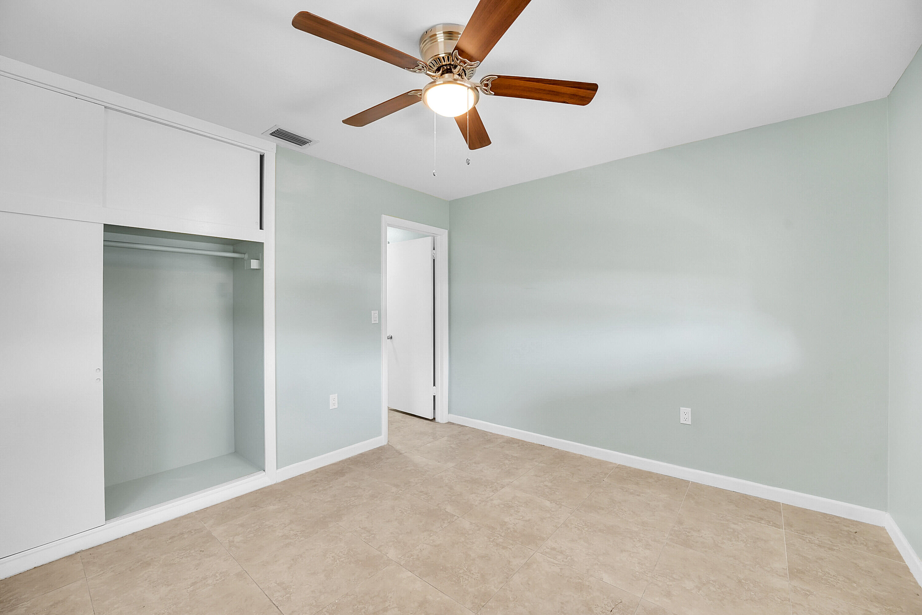 302 West Arbor Avenue Port St. Lucie, FL 34952 - Photo 12 of 25 an empty room with closet and windows