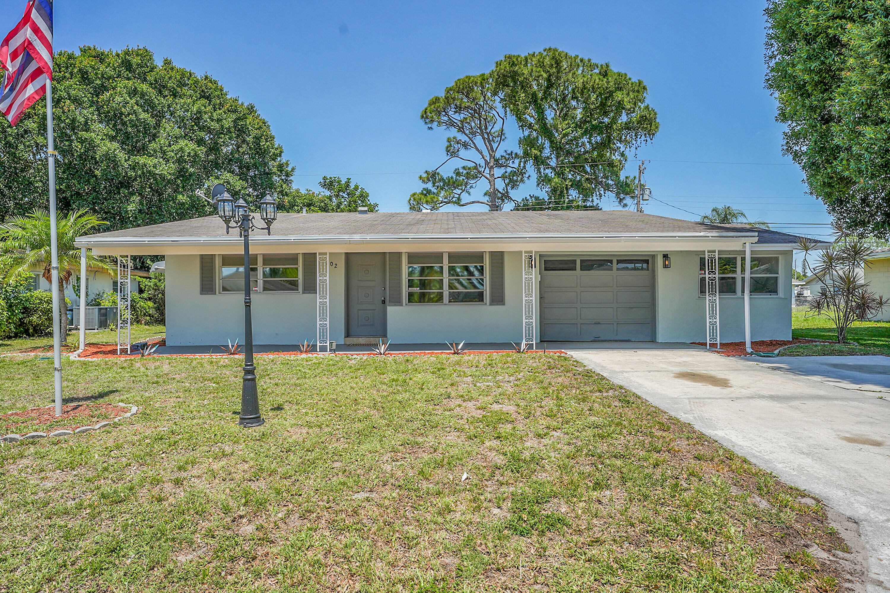 302 West Arbor Avenue Port St. Lucie, FL 34952 - Photo 2 of 25 front view of a house with a yard
