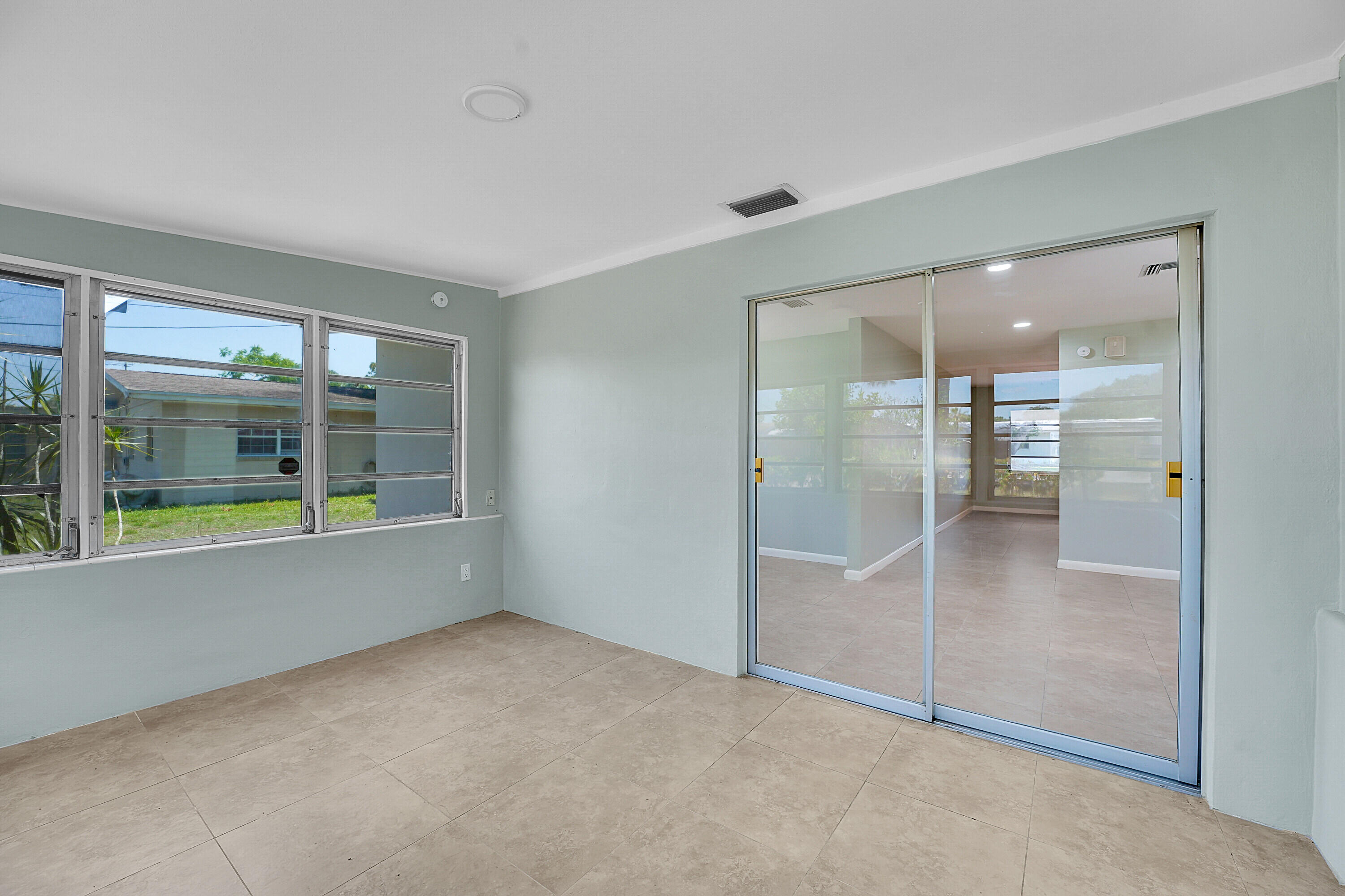 302 West Arbor Avenue Port St. Lucie, FL 34952 - Photo 21 of 25 wooden floor in an empty room with a window