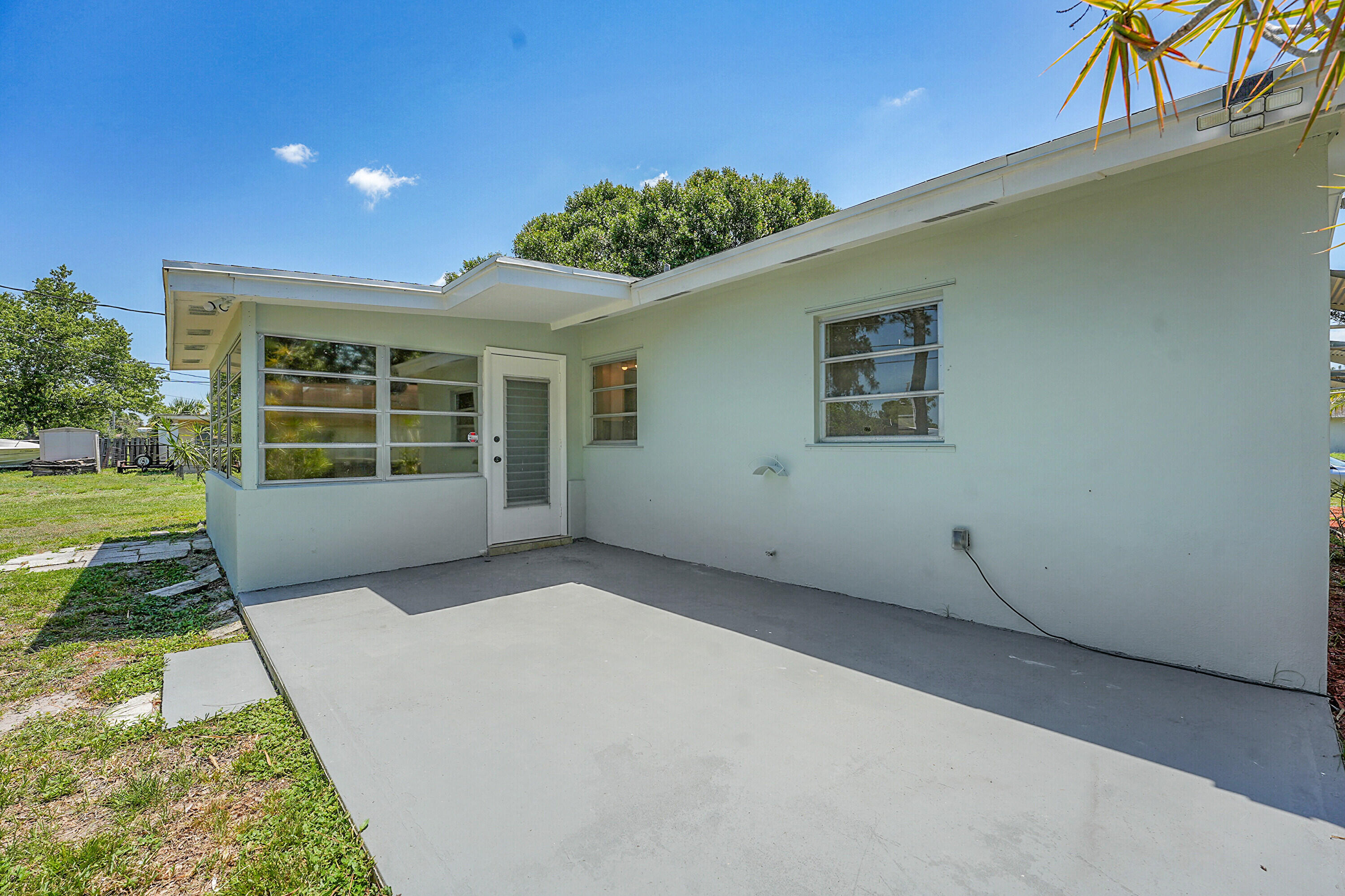 302 West Arbor Avenue Port St. Lucie, FL 34952 - Photo 22 of 25 front view of a house with a yard