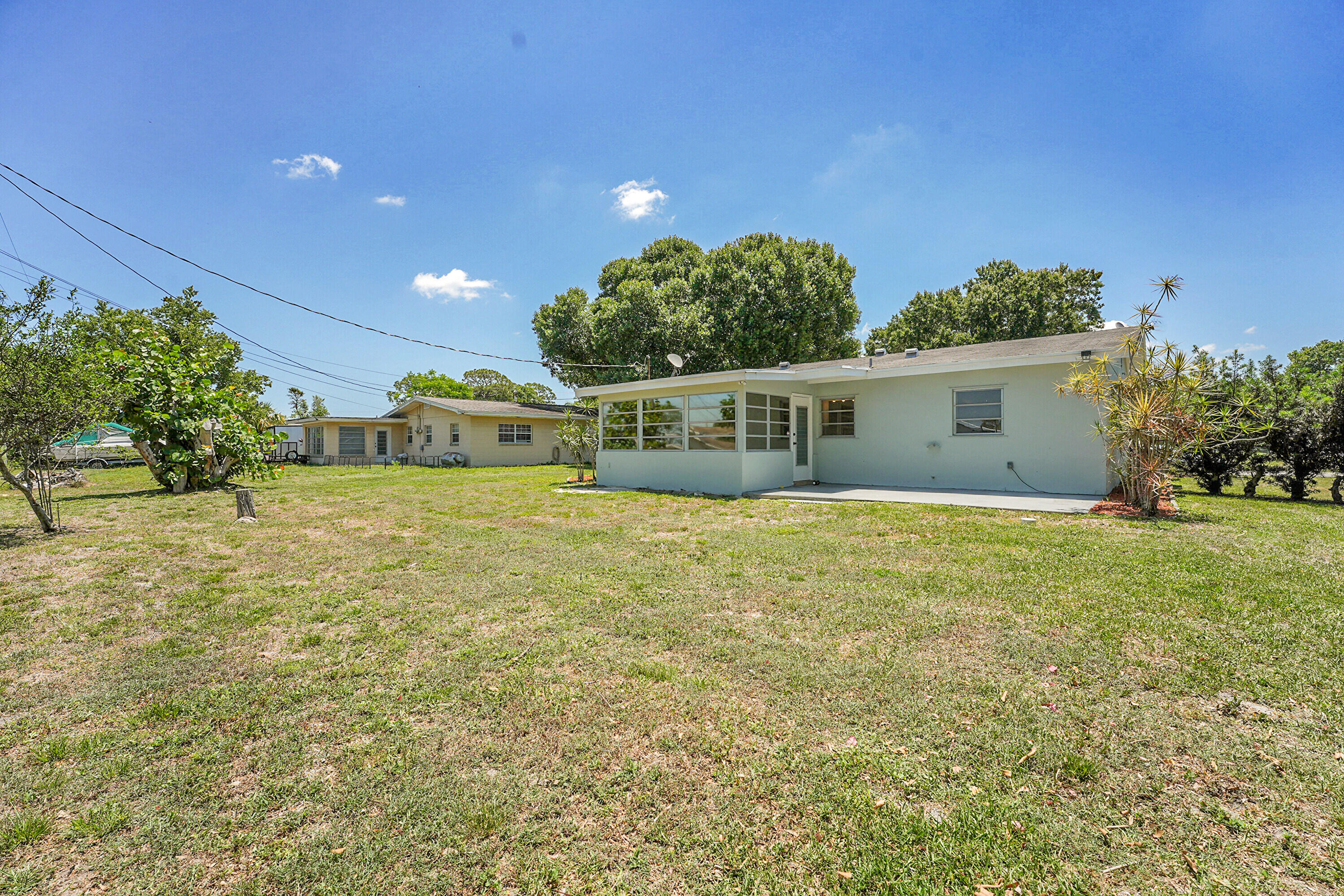 302 West Arbor Avenue Port St. Lucie, FL 34952 - Photo 24 of 25 a view of a house with a backyard