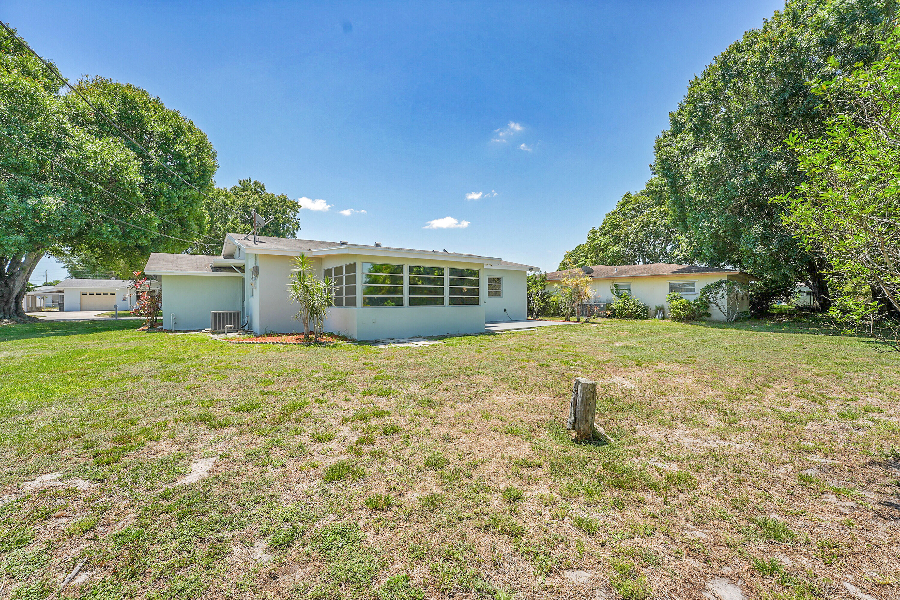 302 West Arbor Avenue Port St. Lucie, FL 34952 - Photo 25 of 25 a view of a house with a yard