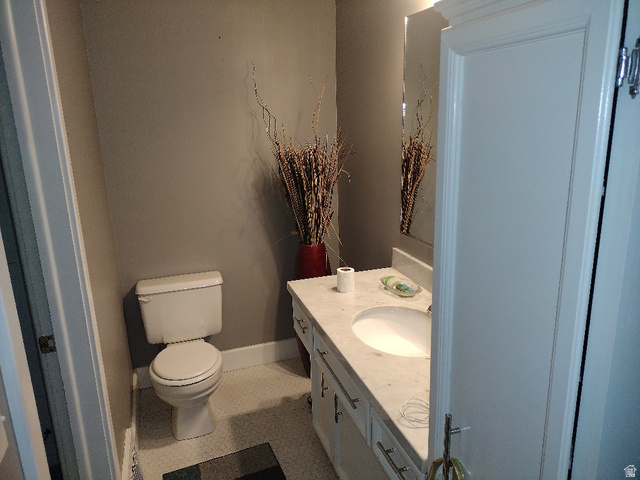 157 West 500 South Logan, UT 84321 - Photo 32 of 38 Bathroom featuring a white vanity with a light-colored countertop, an undermount sink, and a framed mirror
