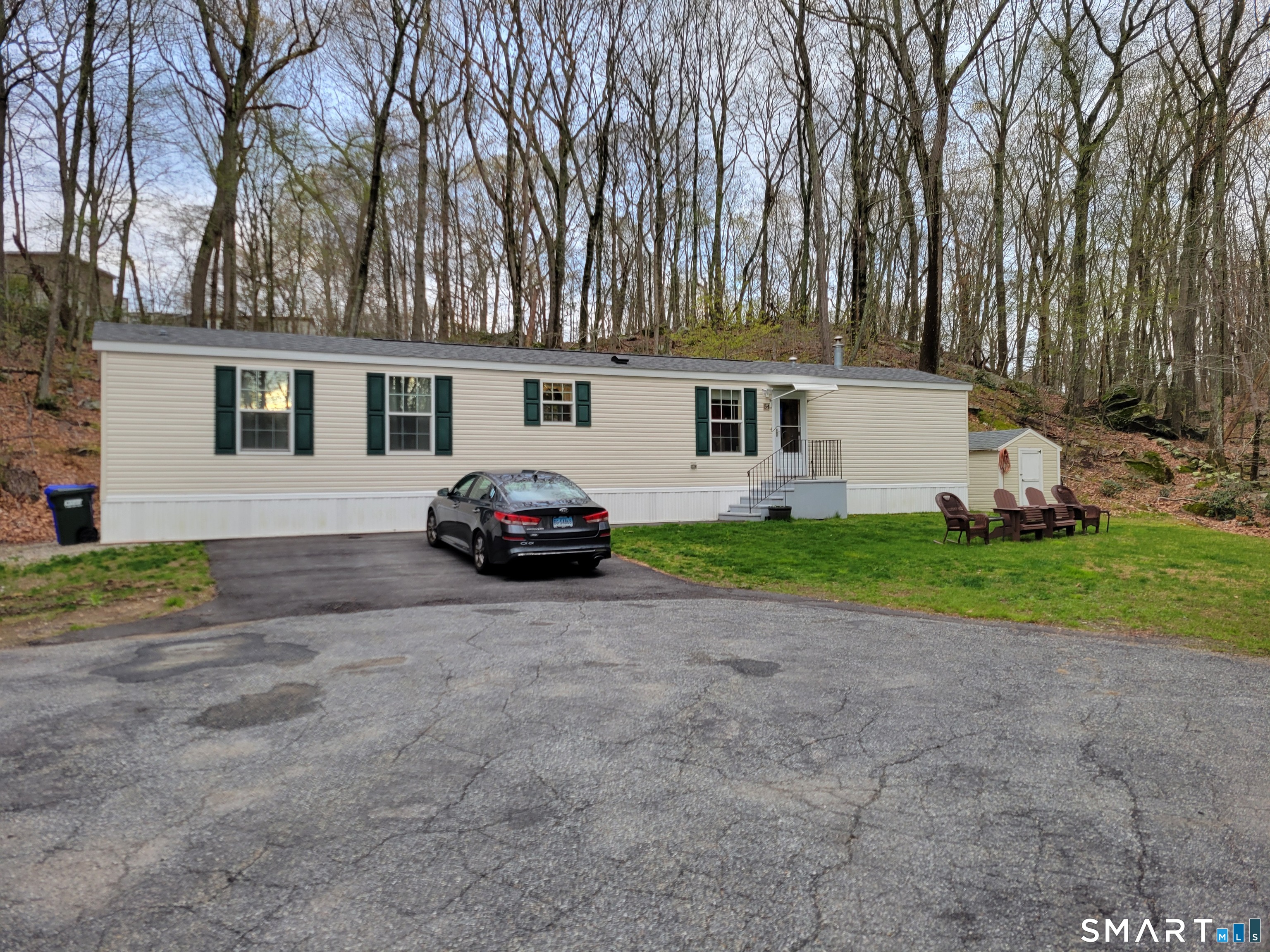 301 Buddington Road Groton, CT 06340 - Photo 2 of 6 a white house that has a tree in front of it
