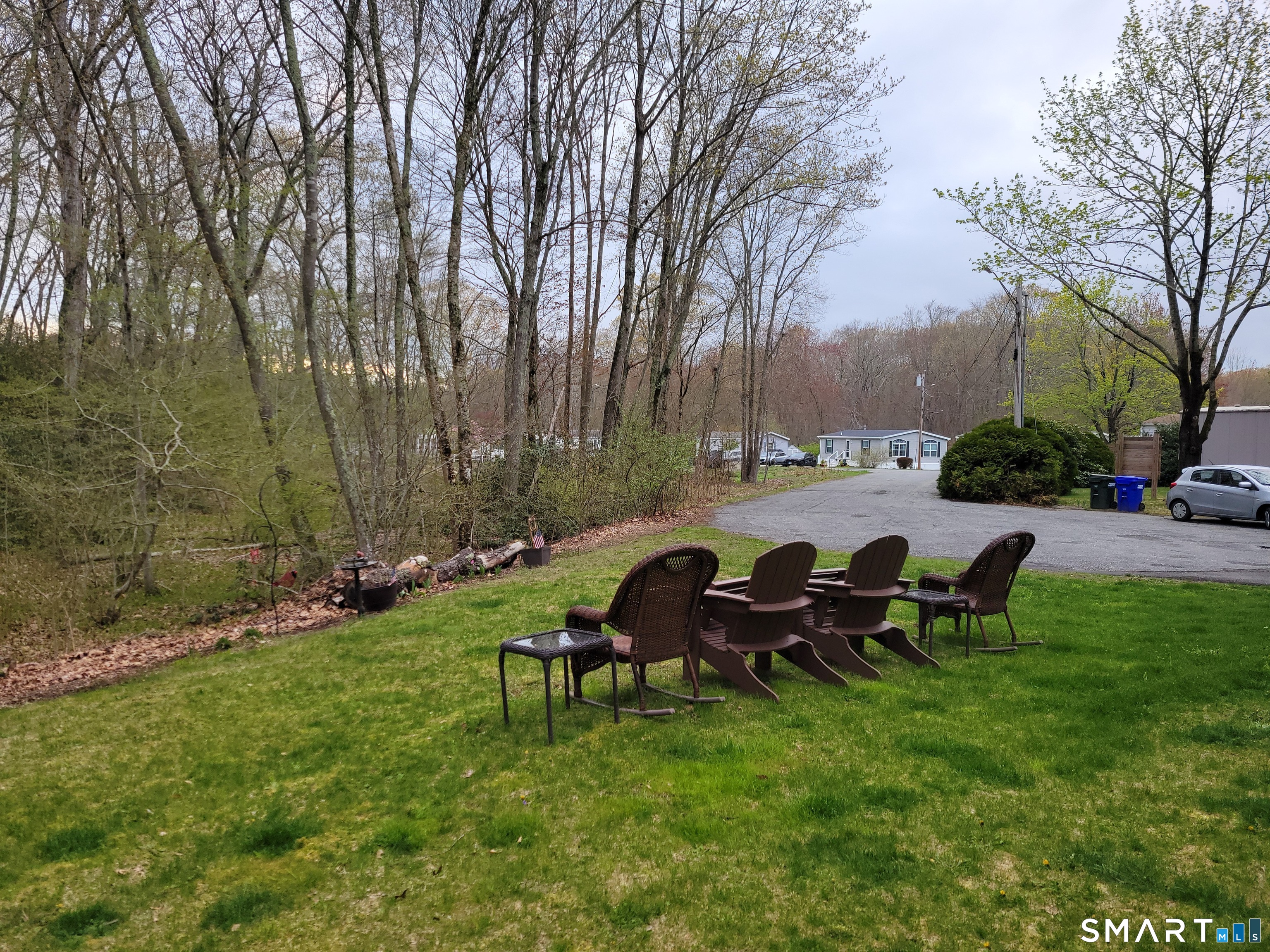 301 Buddington Road Groton, CT 06340 - Photo 6 of 6 a view of a chair and table in the garden