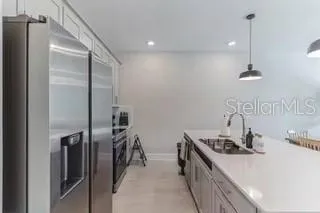 a kitchen with stainless steel appliances a refrigerator and a sink