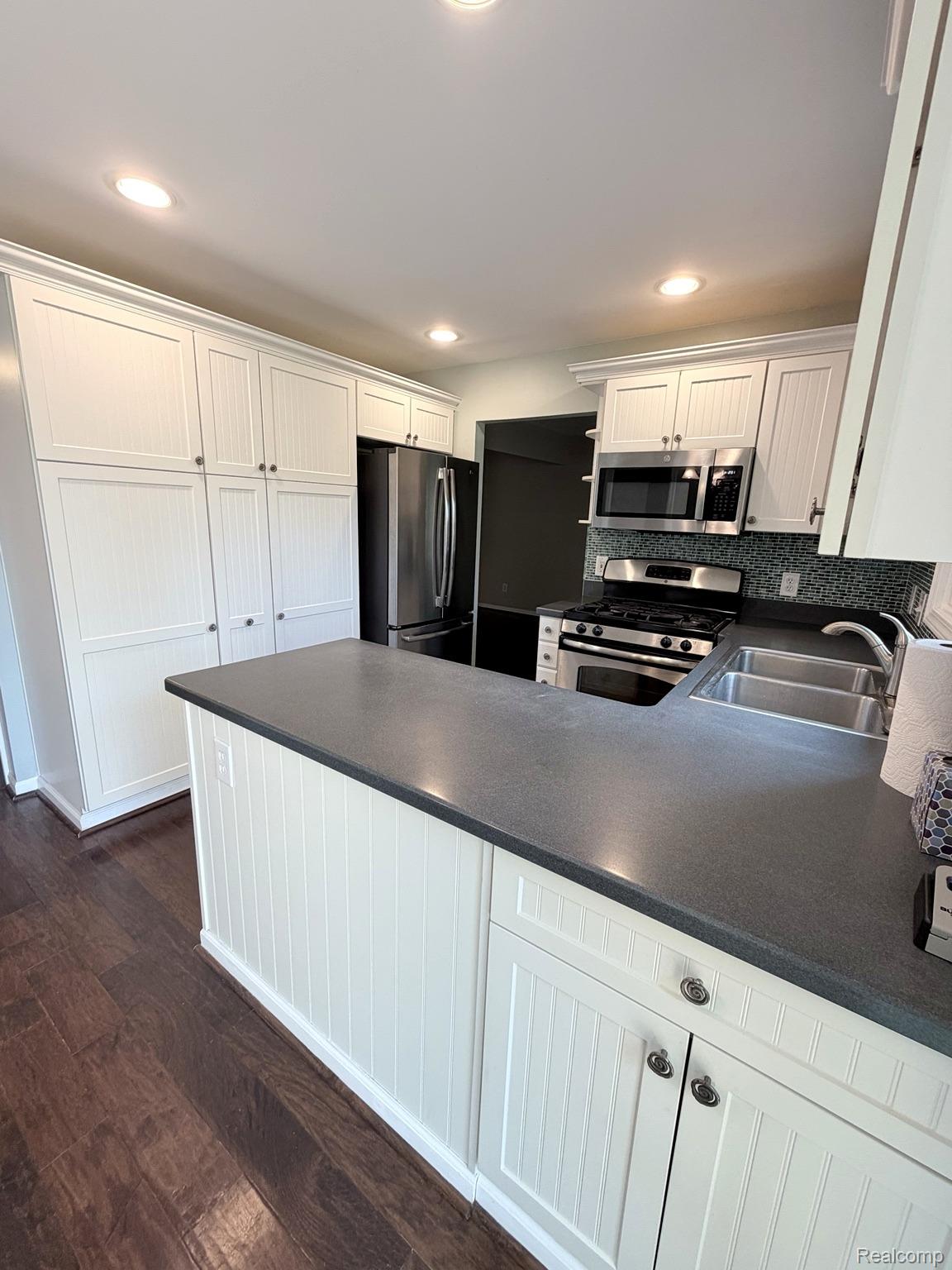 2070 Winchester Road Rochester, MI 48307 - Photo 10 of 34 White cabinetry with beadboard paneling and dark hardware