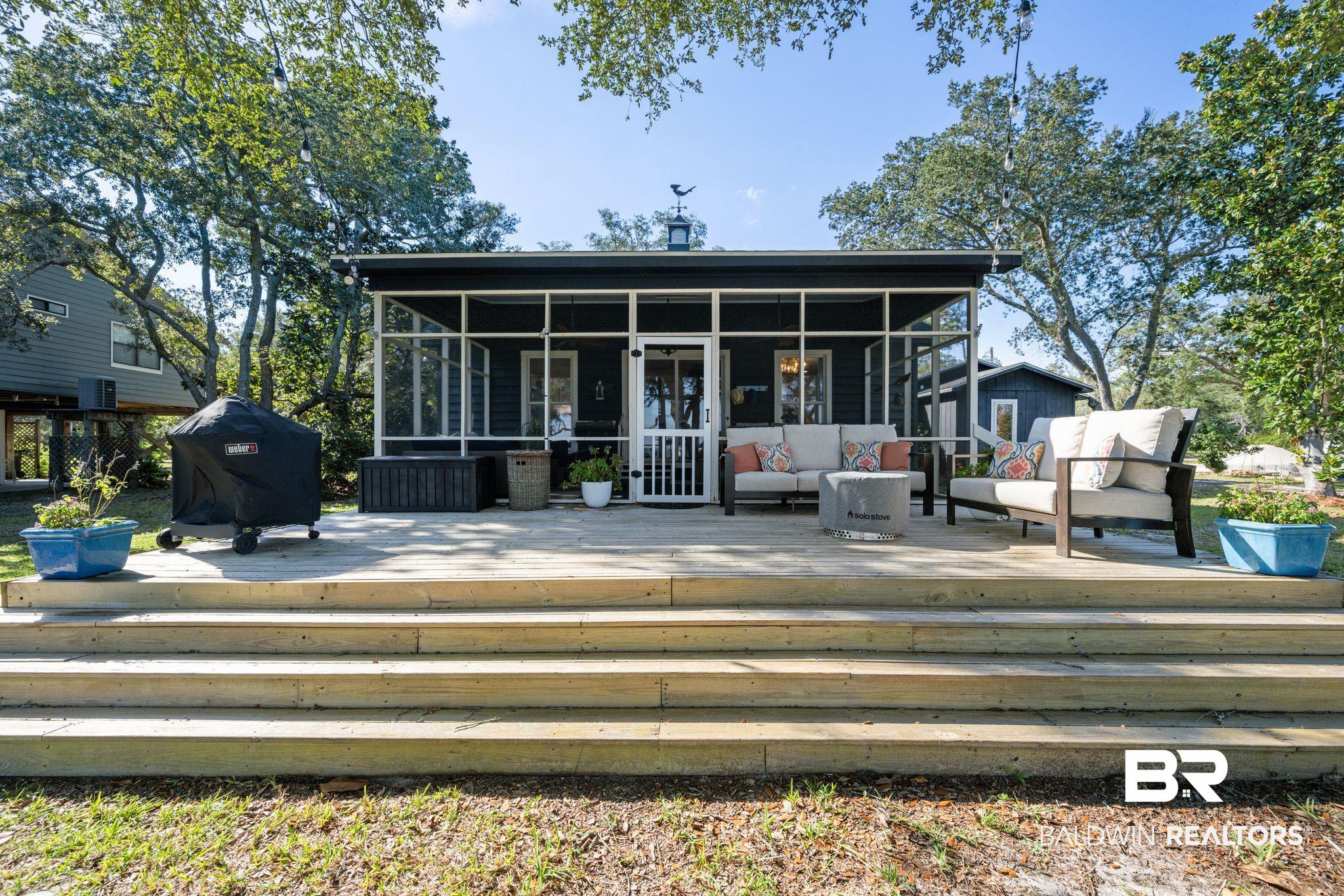 7646 Spring Branch Road Elberta, AL 36530 - Photo 60 of 85 Back of house with a deck, an outdoor living space, and a sunroom