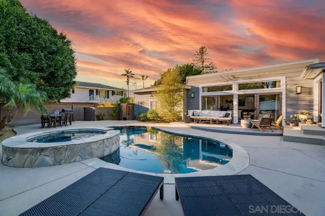 a view of a house with pool and chairs