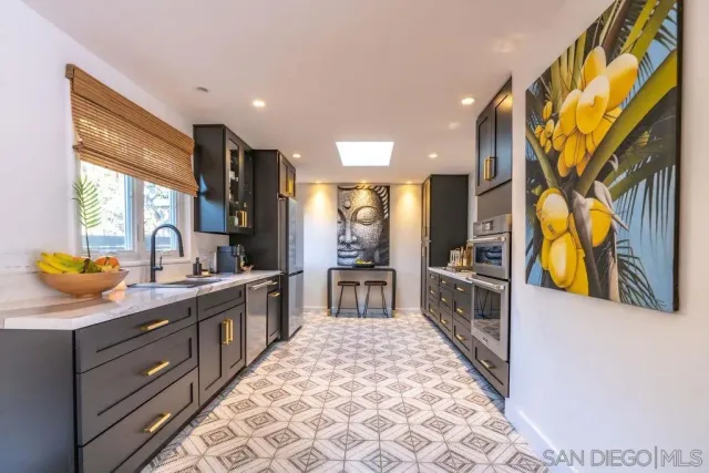 a large kitchen with stainless steel appliances granite countertop a stove a sink and a microwave