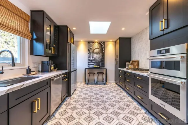 a living room with furniture a large window and a chandelier