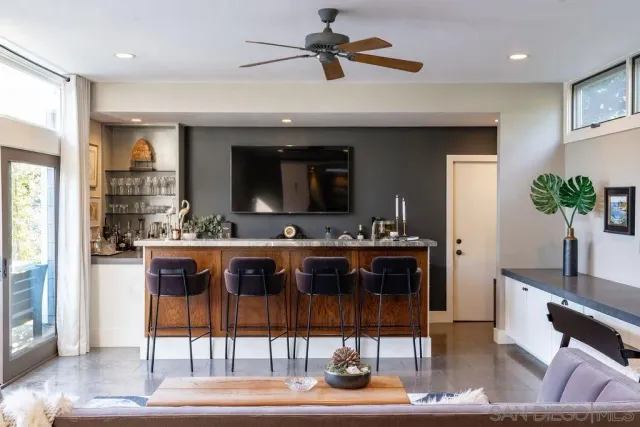 a living room with hardwood floor and a floor to ceiling window