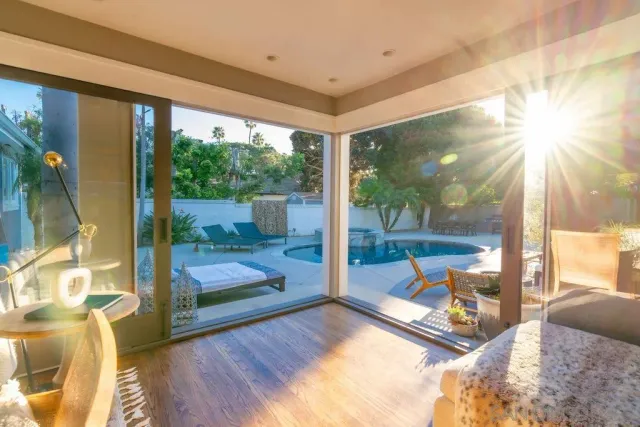 a bedroom with furniture and a large window