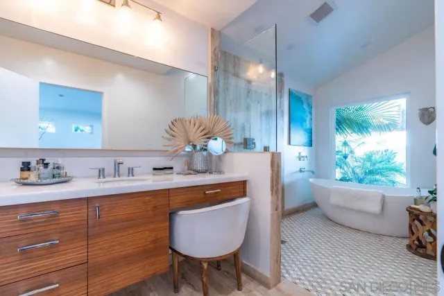 a spacious bedroom with a large bed and a large window