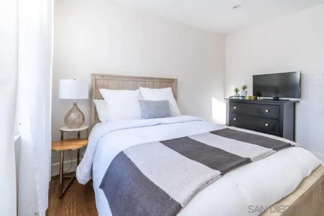 a bedroom with a bed and a large window