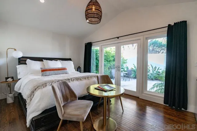 a bathroom with a granite countertop sink mirror vanity and toilet