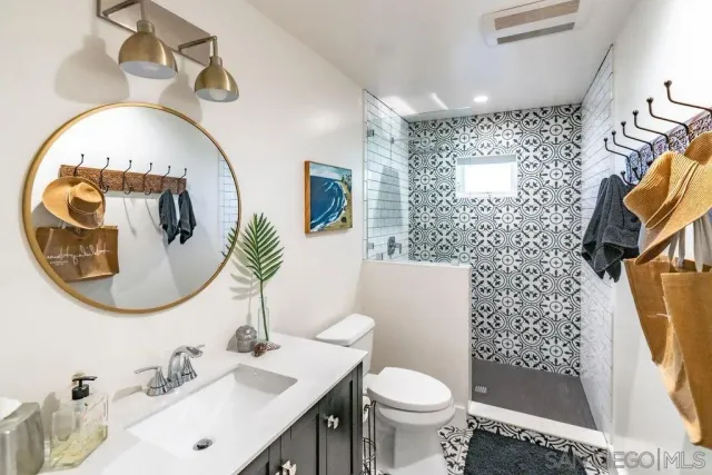 a spacious bathroom with a granite countertop sink and a mirror