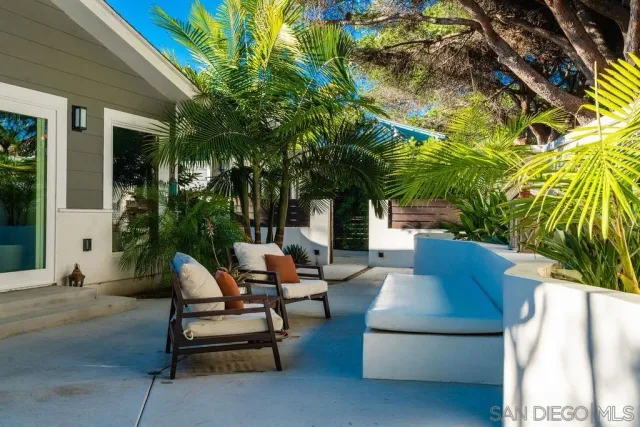 a view of patio with couches and a fire pit