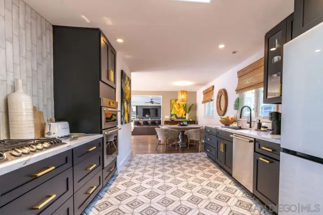 a kitchen with a sink cabinets and a window