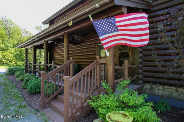 a front view of house with yard and staircase