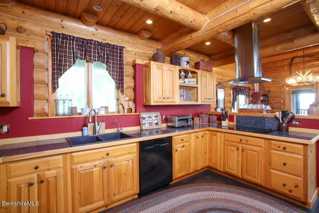 a kitchen with sink stove and cabinets
